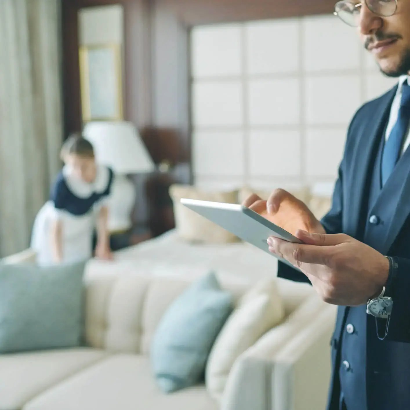 Hotel staff coordinating room service using modern technology